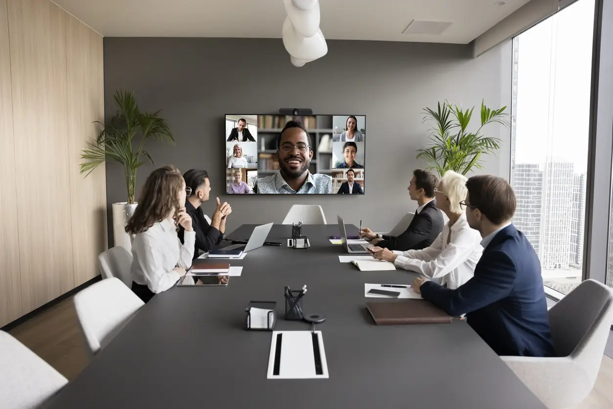 Modern conference room with a team meeting around a long table