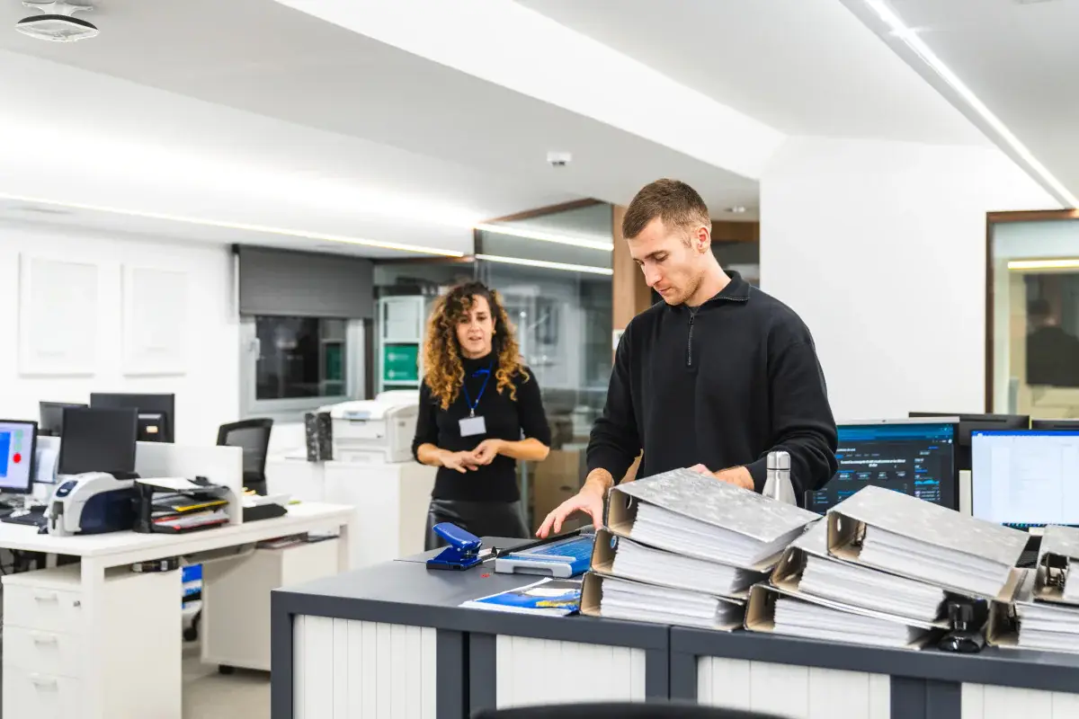 Staff setting up equipment in a temporary office