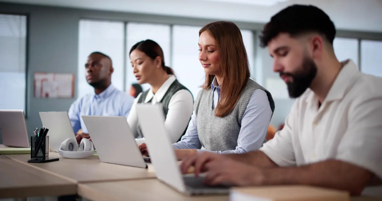 Training participants following along on laptops in a computer class