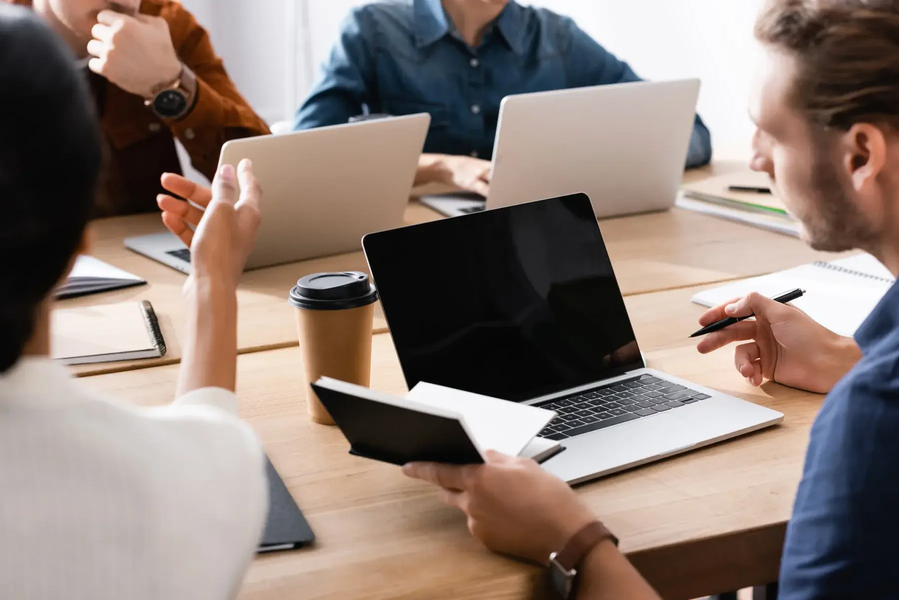 Business team working on laptops during a meeting