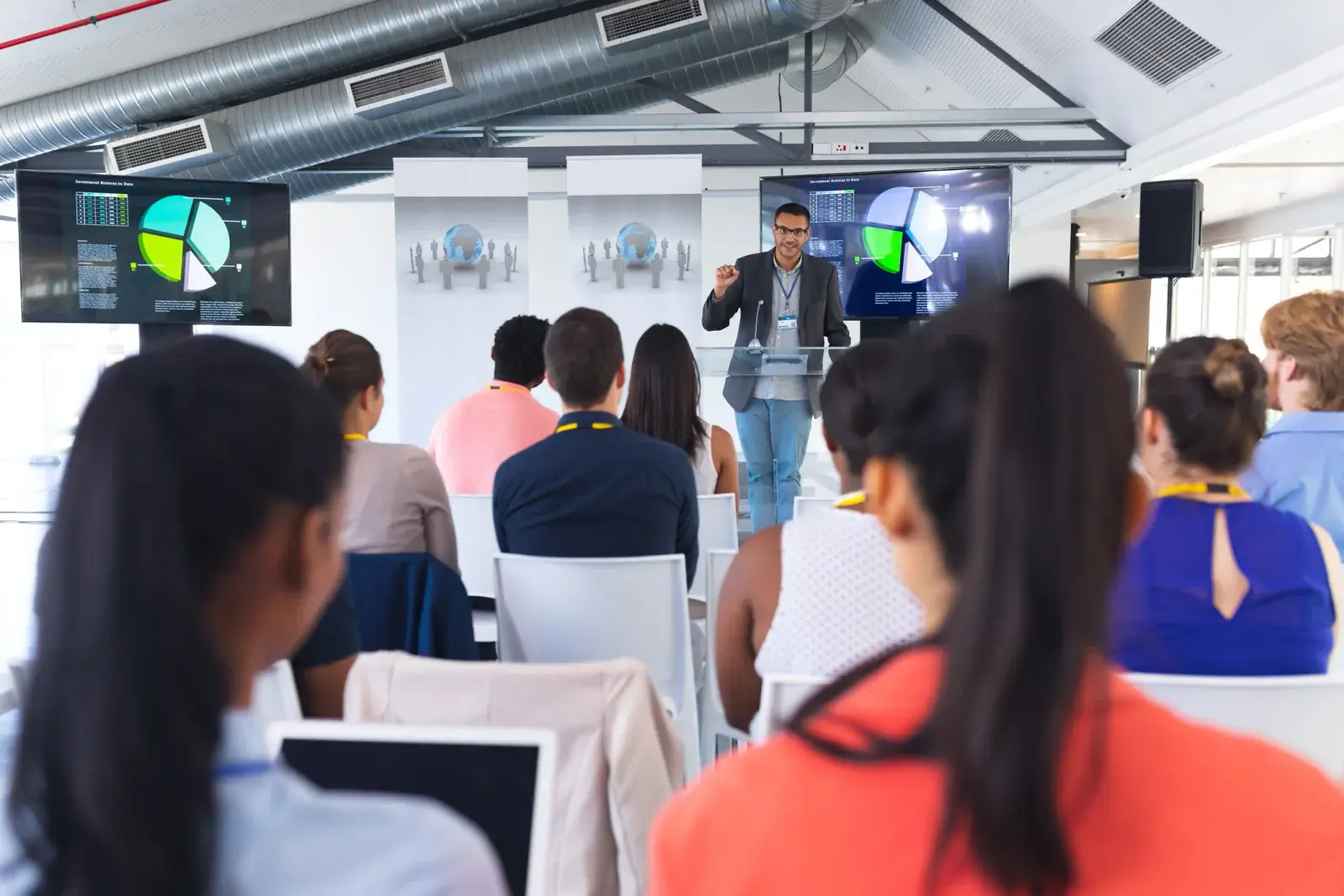 Corporate employees attending a training session with laptops