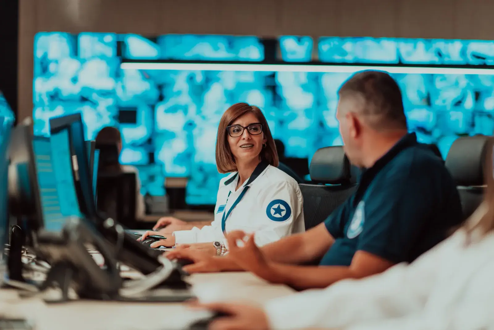 Hospital operations staff working at computers in an incident command center