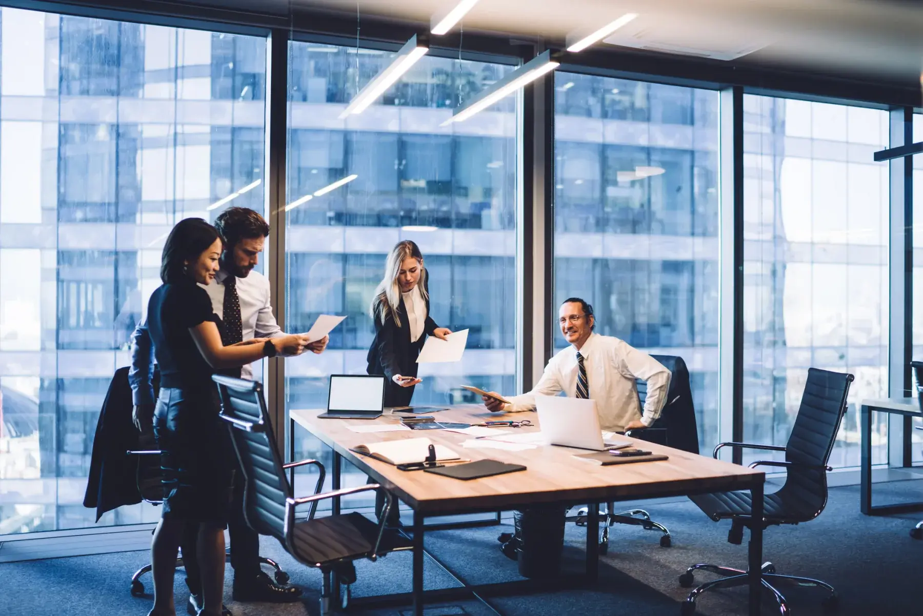 Legal team working on laptops in a high-rise conference room