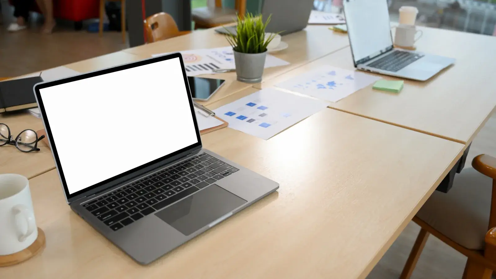 Open laptop on a clean desk, set up and ready for its user